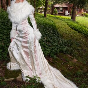 Woman modeling an Elegant Champagne, Cream Evening Gown with Train and Faux Fur in outdoor setting